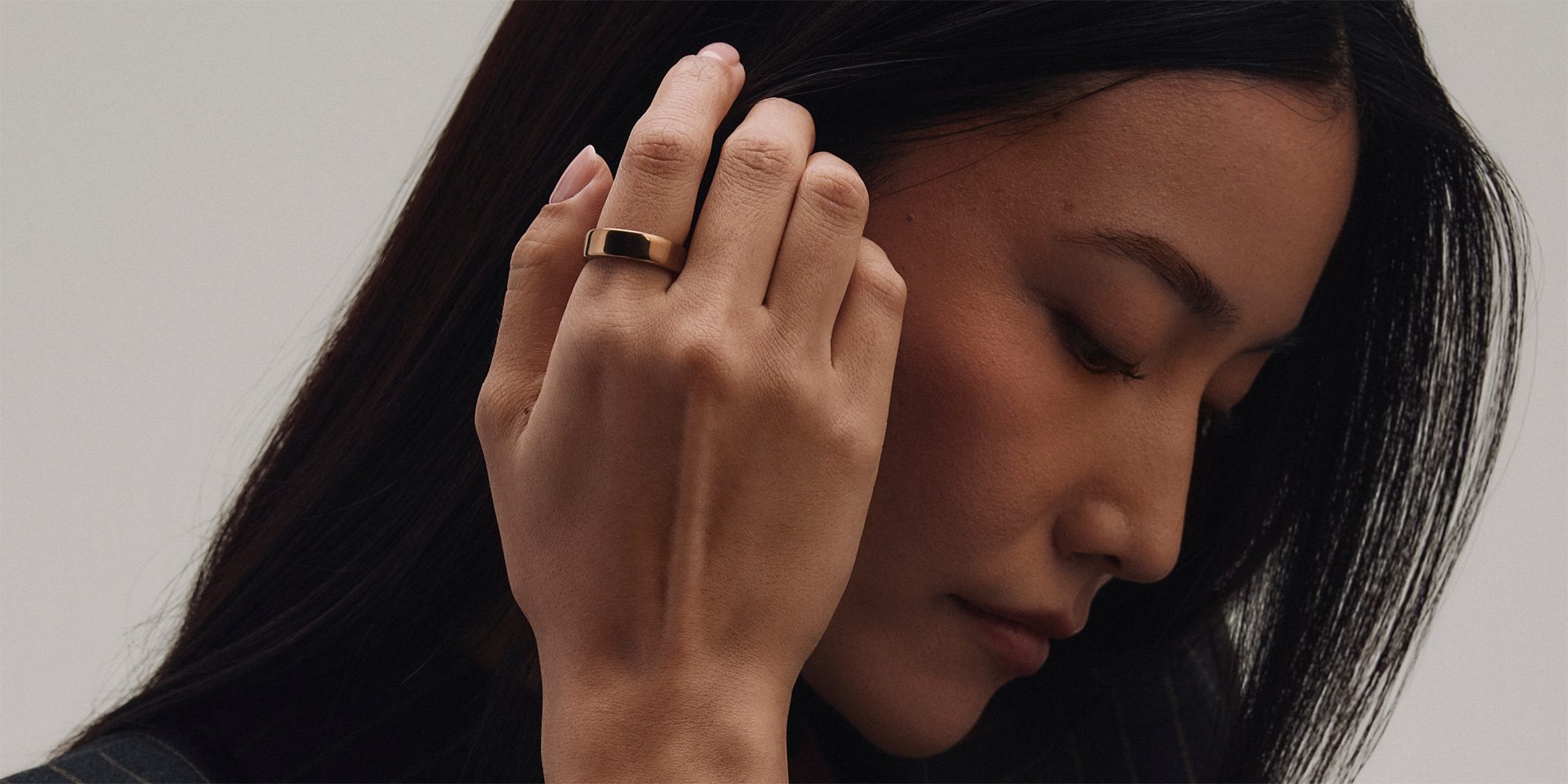 The Oura Ring 5 is the smart wearable you won't know you're wearing | Photoshow shows a woman wearing the rose gold finish