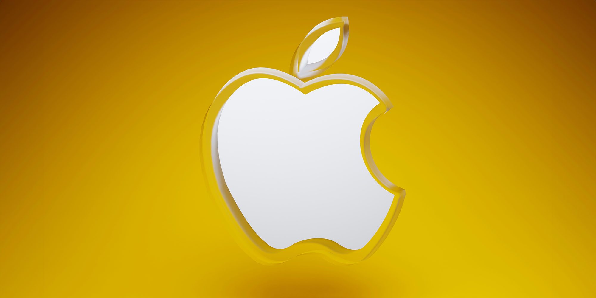 Analysts believe Apple taking a highly unusual step to double Mac user base | Render of an acrylic Apple logo against a vibrant yellow-orange background