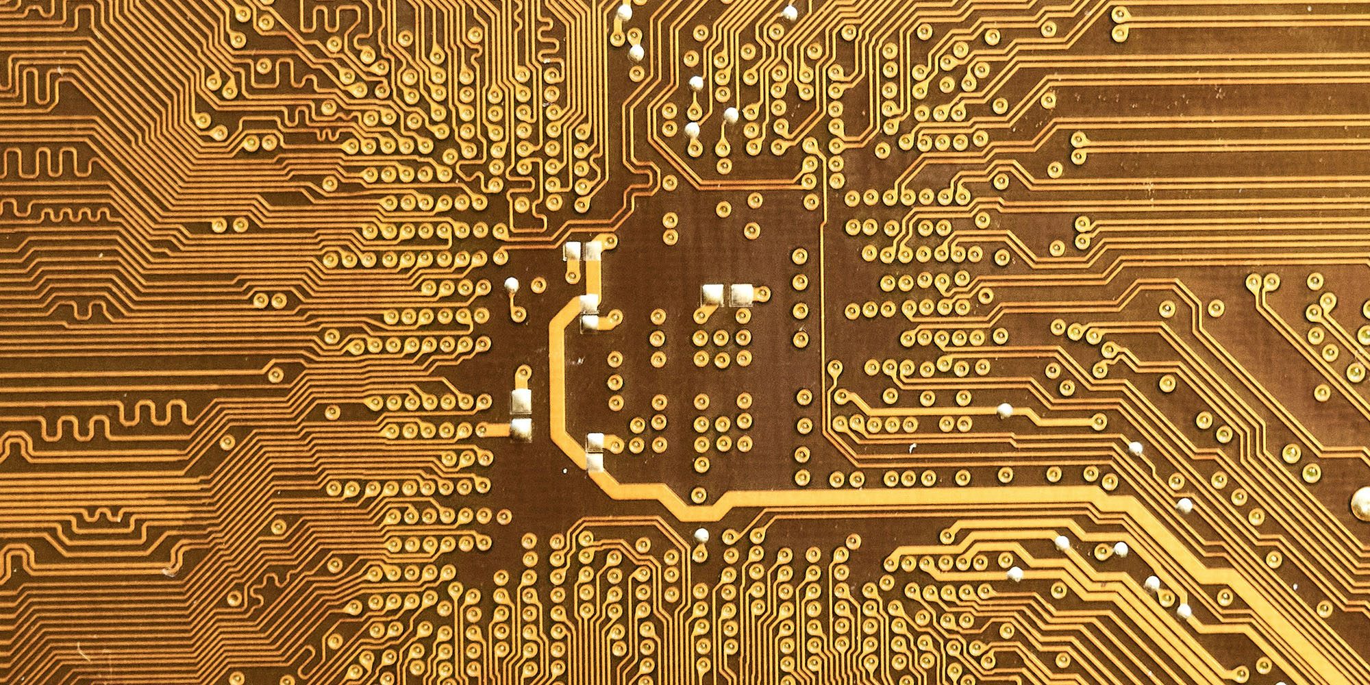 Apple announces 30B Broadcom chip contract as part of 600B US investment promise | Close-up photo of a gold silicon chip