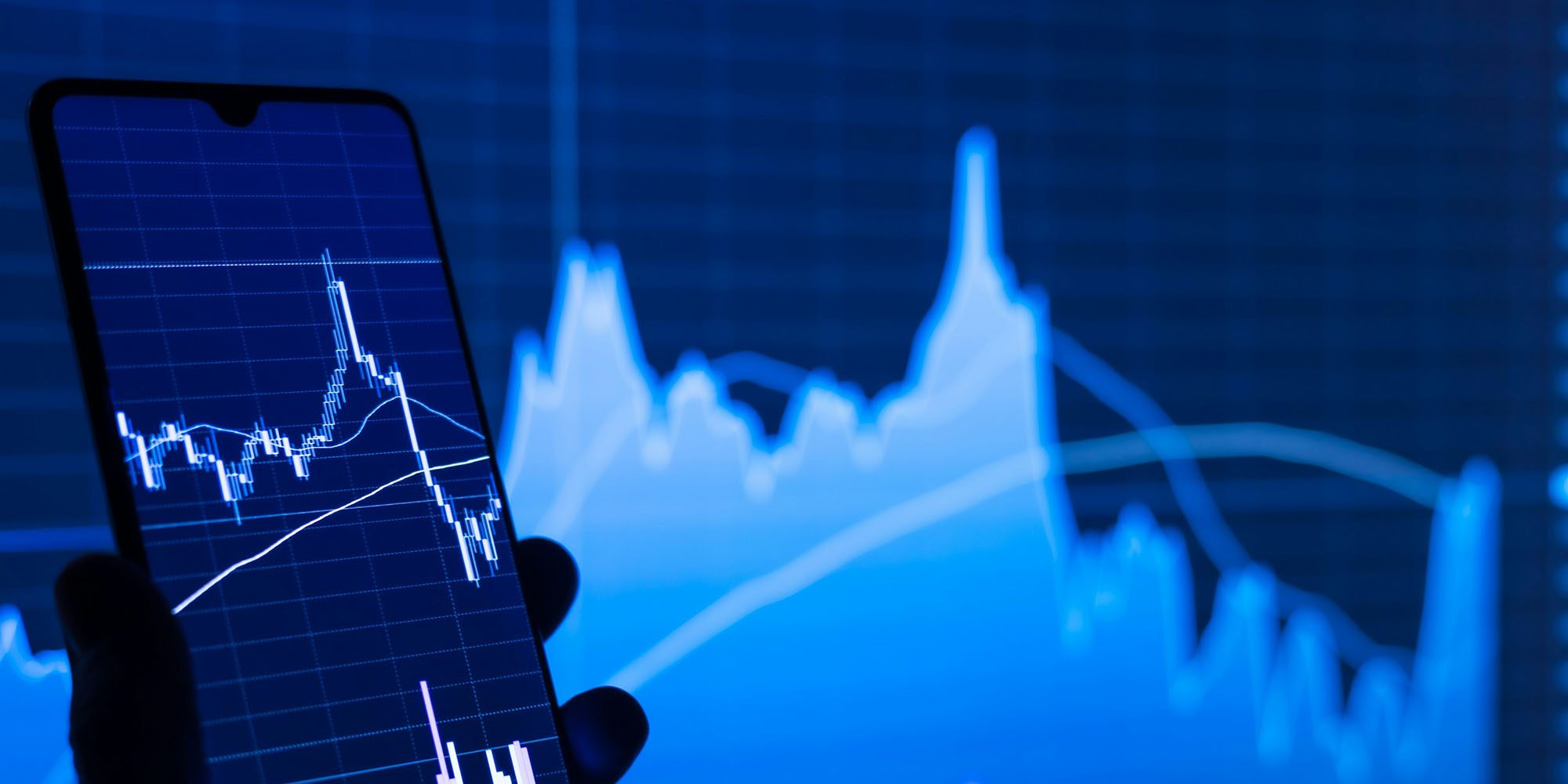 Apple supplier Luxshare share listing sets new record then slides back | Stock photo shows graphs on a smartphone and computer screen