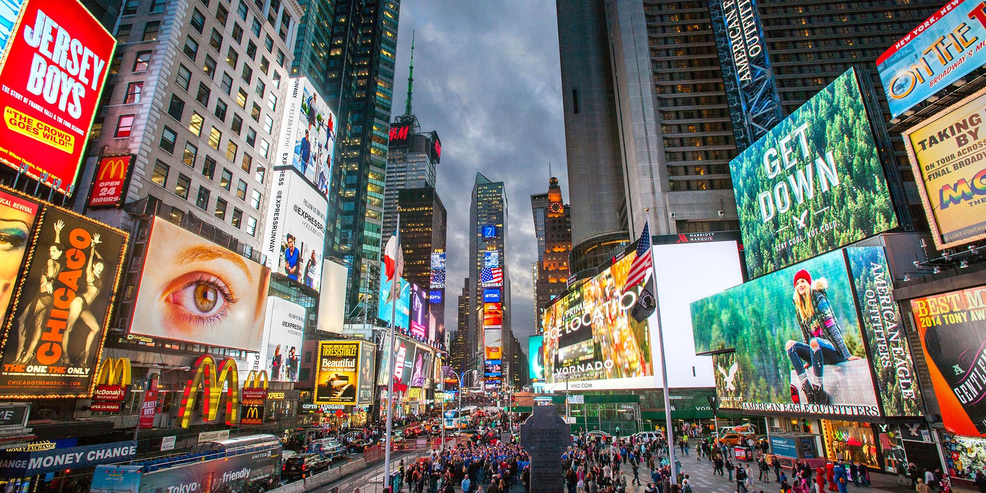Should Apple get out of the ad business altogether | Photo shows illuminated billboards in New York's Times Square