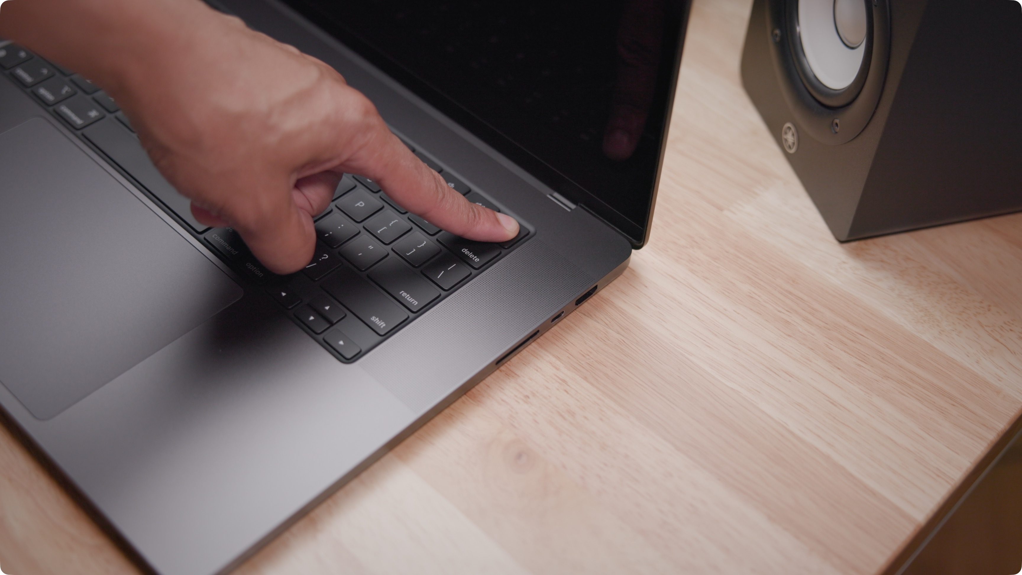 Pressing power on MacBook Pro for system startup recovery options